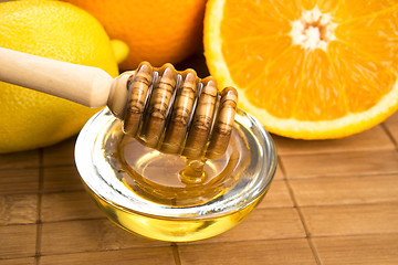 Image showing fresh honey with lemon and orange fruits