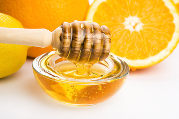 Image showing fresh honey with lemon and orange fruits