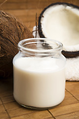 Image showing coconut fruit with a jar filled with coco milk