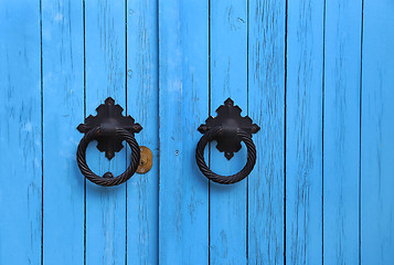 Image showing Blue wooden door with round handles