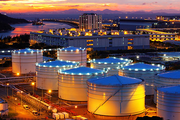 Image showing Oil tanks at sunset