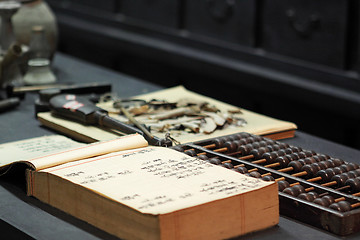 Image showing abacus and book on the table in a chinese old shop