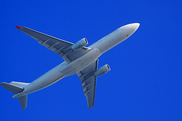 Image showing Passenger jet air plane flying on blue sky