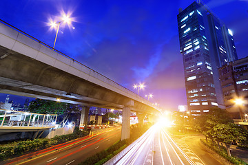 Image showing moving car with blur light through city at night 