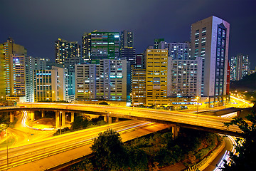 Image showing Colorful city night with buildings and bridge