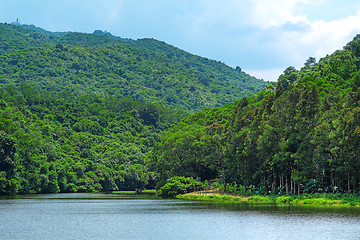 Image showing Landscape of trees with reflection on lake under blue sky. 