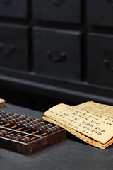 Image showing abacus and book on the table in a chinese old shop