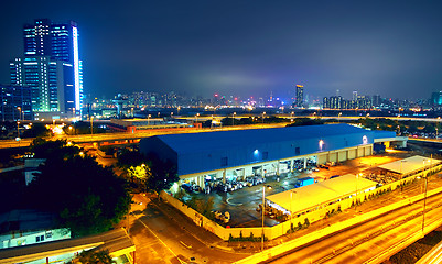 Image showing urban landscape at night and through the city traffic 