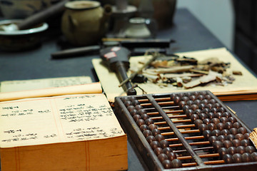 Image showing abacus and book on the table in a chinese old shop