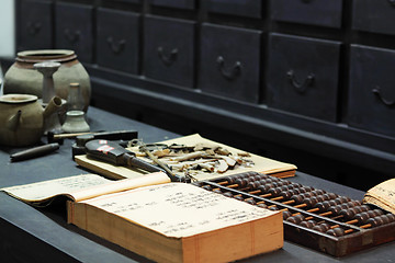 Image showing abacus and book on the table in a chinese old shop