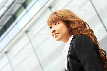 Image showing young business woman and an office background