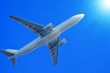 Image showing Passenger jet air plane flying on blue sky