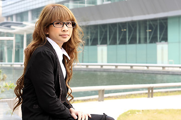 Image showing young business woman and an office background