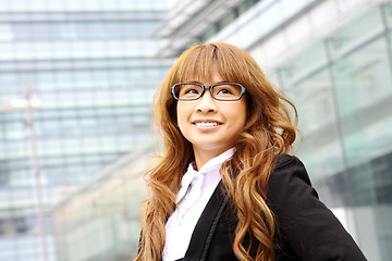 Image showing young business woman and an office background