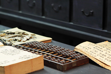 Image showing abacus and book on the table in a chinese old shop