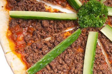 Image showing Turkish beef pizza with cucumber on top