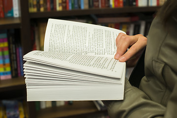 Image showing Open book in a bookstore