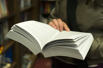 Image showing Open book in a bookstore