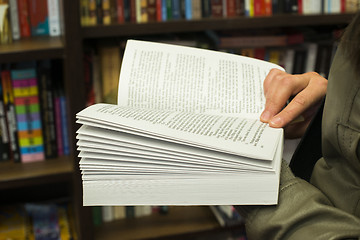 Image showing Open book in a bookstore