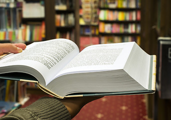 Image showing Open book in a bookstore