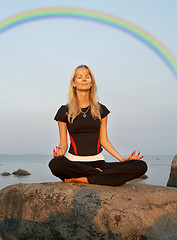 Image showing meditation at the seashore under rainbow