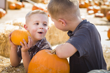 Image showing Two Boys at the Pumpkin Patch Talking and Having Fun
