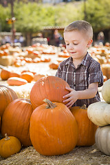 Image showing Little Boy Gathering His Pumpkins at a Pumpkin Patch
