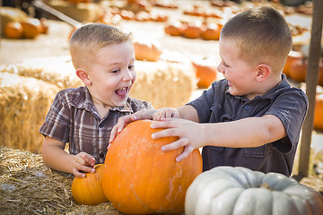 Image showing Two Boys at the Pumpkin Patch Talking and Having Fun
