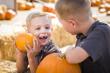 Image showing Two Boys at the Pumpkin Patch Talking and Having Fun
