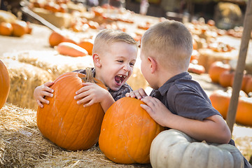 Image showing Two Boys at the Pumpkin Patch Talking and Having Fun
