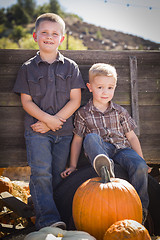 Image showing Two Boys at the Pumpkin Patch Against Antique Wood Wagon