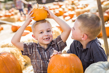 Image showing Two Boys at the Pumpkin Patch Talking and Having Fun
