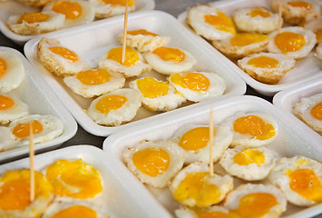 Image showing Fried quail eggs on the market close up