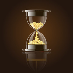 Image showing Hourglass with gold coins over dark background.