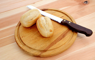 Image showing Closeup of two fresh petit pain with a bread knife