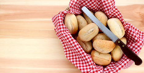 Image showing Basket of petit pain and a bread knife 