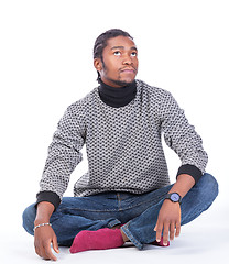 Image showing Young African-American male sitting on the ground