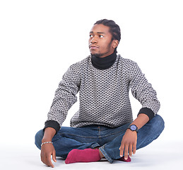 Image showing Young African-American male sitting on the ground