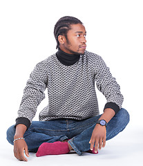 Image showing Young African-American male sitting on the ground