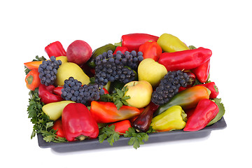 Image showing Fruits , pepper and parsley leaves on a plate on a white backgro