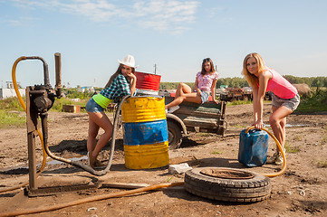 Image showing young women on old gasoline station