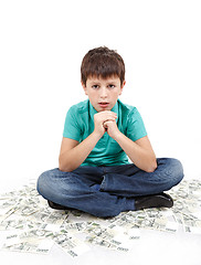 Image showing boy sitting on money