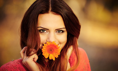 Image showing Girl with a flower in his mouth