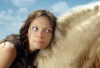 Image showing Close-up portrait of the woman on a horse back