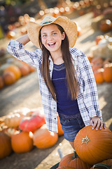Image showing Preteen Girl Playing with a Wheelbarrow at the Pumpkin Patch
