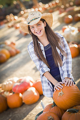 Image showing Preteen Girl Playing with a Wheelbarrow at the Pumpkin Patch
