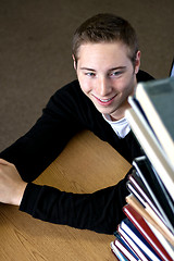 Image showing Student Looking At Book Stack