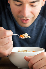 Image showing Man Eating Chicken Soup