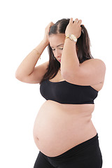 Image showing A young pregnant woman is experiencing the discomfort of pregnan