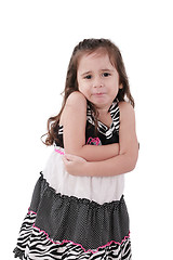 Image showing angry little girl in dress with arms crossed on white background